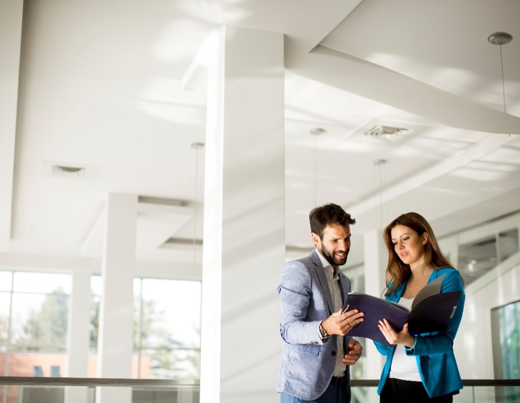 Two people looking at a folder
